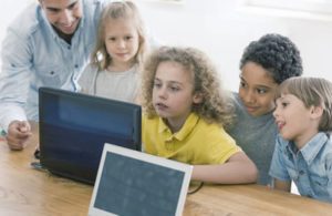 children looking at computer screen